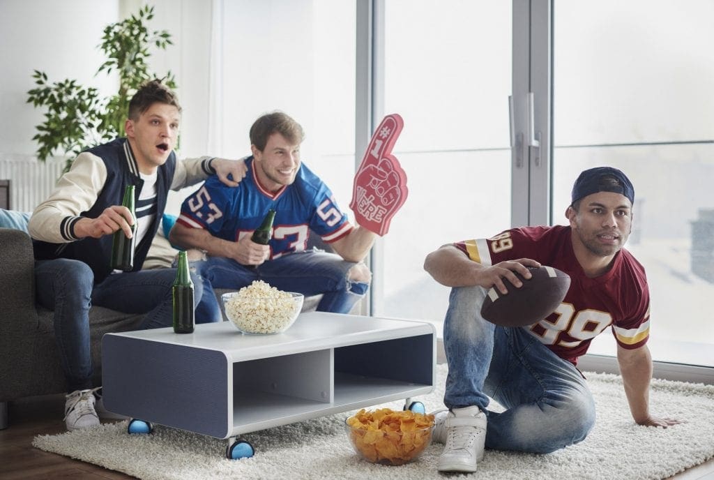 American football fans in front of tv
