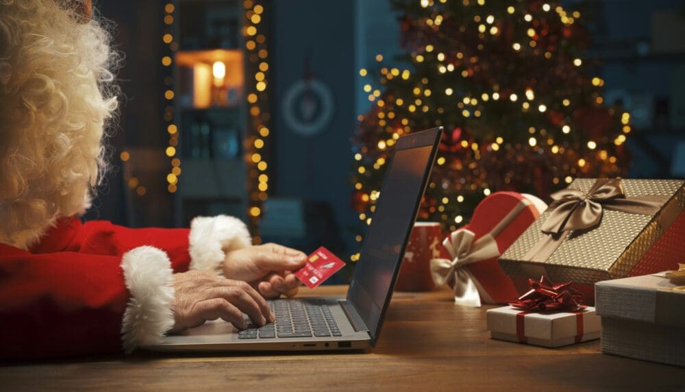 Santa doing online shopping at Christmas